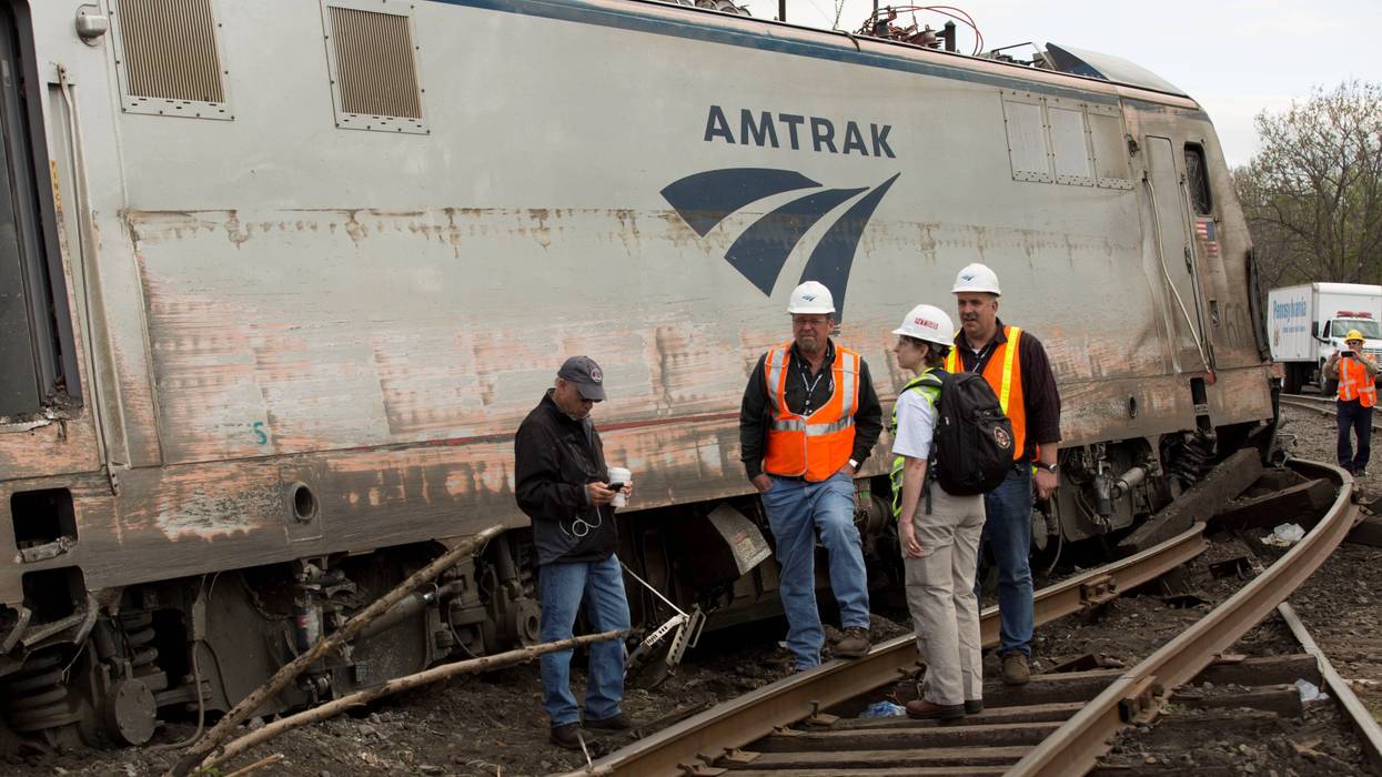 NTSB Recorder Specialist Cassandra Johnson (second from right) works with officials on the scene of the Amtrak Train 188 derailment on May 13, 2015 in Philadelphia, Pennsylvania.