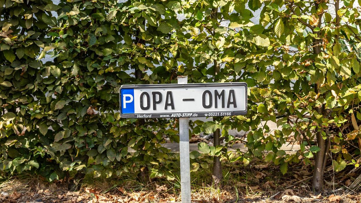 number plate at a parking lot with names Oma and Opa, in english Grandmother, Grandfather to reserve a parking lot for elderly people