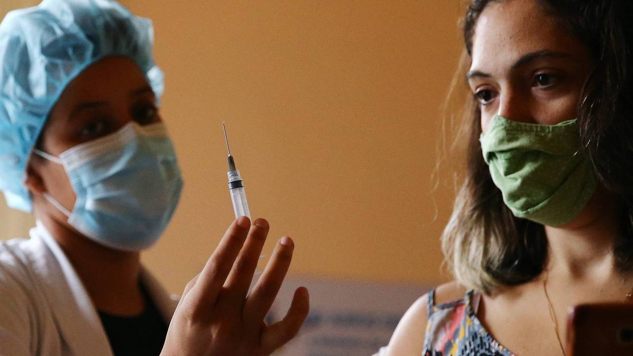 Nurse-in-training Julia Ramos displays the empty syringe after vaccinating a person at a COVID-19 vaccination clinic at Museu da Republica (Museum of the Republic) on May 24, 2021 in Rio de Janeiro, Brazil.