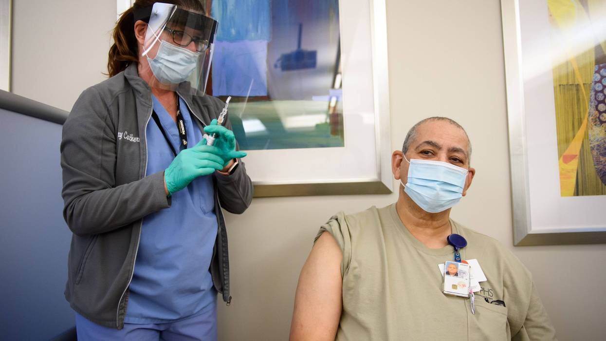 Nurse Mary Catherine Klee injects a COVID-19 vaccine dose into Housekeeper Mecrecco Pogue, 68, at the Pittsburgh VA Medical Center on December 17, 2020 in Pittsburgh, Pennsylvania
