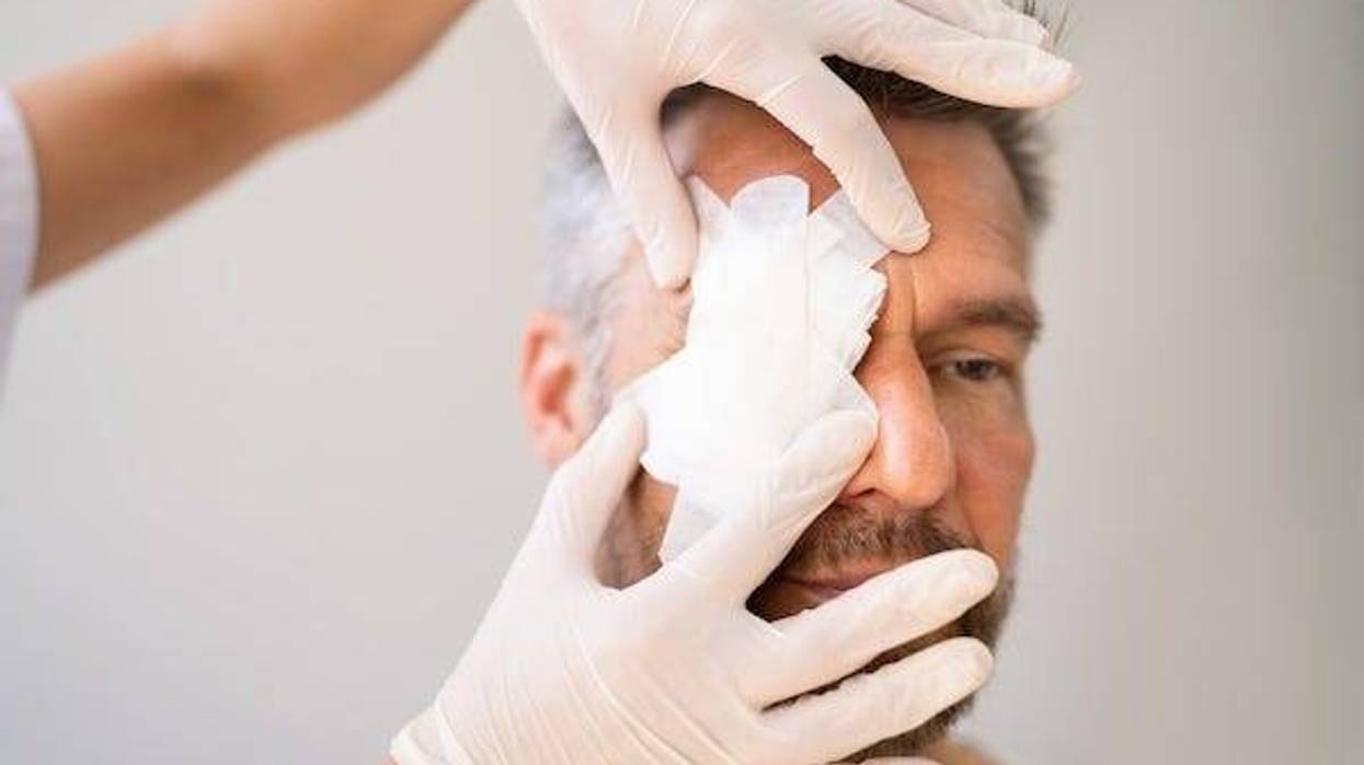 Nurse putting a bandage over a man’s eye