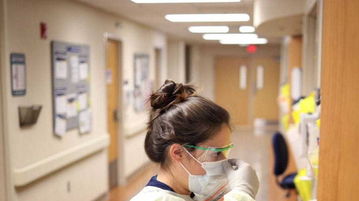 Nurses in the COVID-19 unit of MedStar St. Mary's Hospital check the fit of protective equipment before entering a patient's room March 24, 2020 in Leonardtown, Maryland.