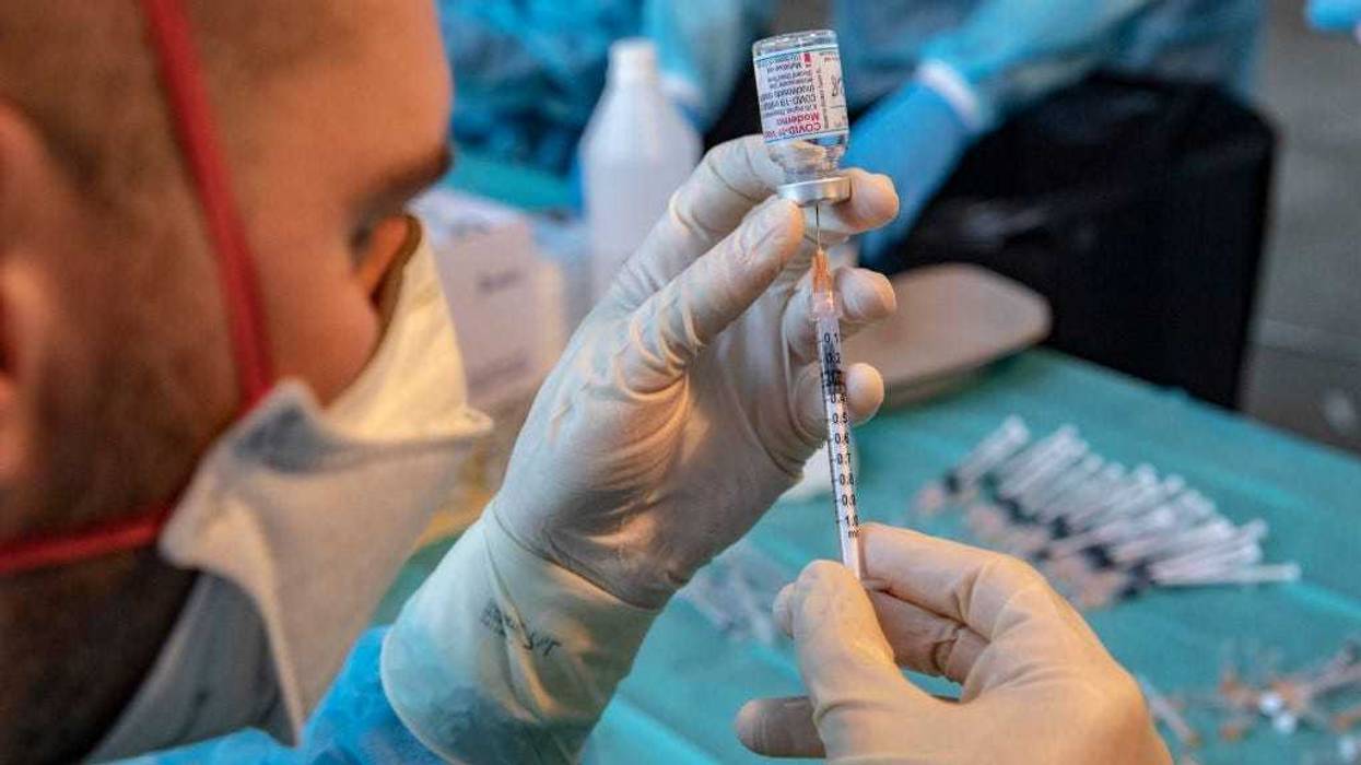Nurses prepare and check vaccine syringes at FieraMesse, the Bolzano trade fair center, during the Covid 19 vaccination marathon in South Tyrol, on December 11, 2021 in Bolzano, Italy.