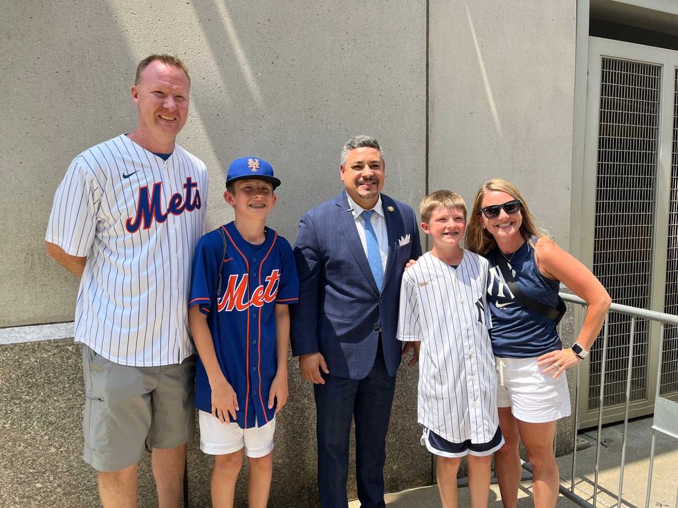 NYPD commissioner Edward Caban (center) meets with Subway Series fans outside Yankees Stadium