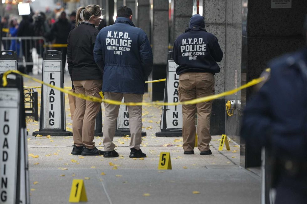 NYPD crime scene police work the scene where UnitedHealthcare CEO Brian Thompson, 50, was shot as he entered the New York Hilton early on December 4, 2024