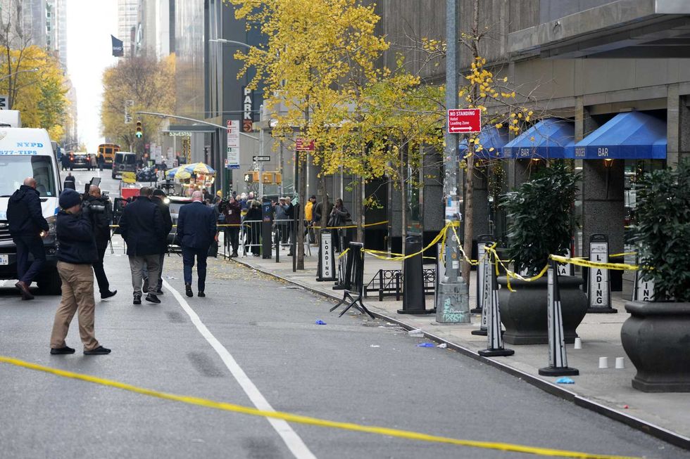 NYPD crime scene police work the scene where UnitedHealthcare CEO Brian Thompson, 50, was shot as he entered the New York Hilton early on December 4, 2024