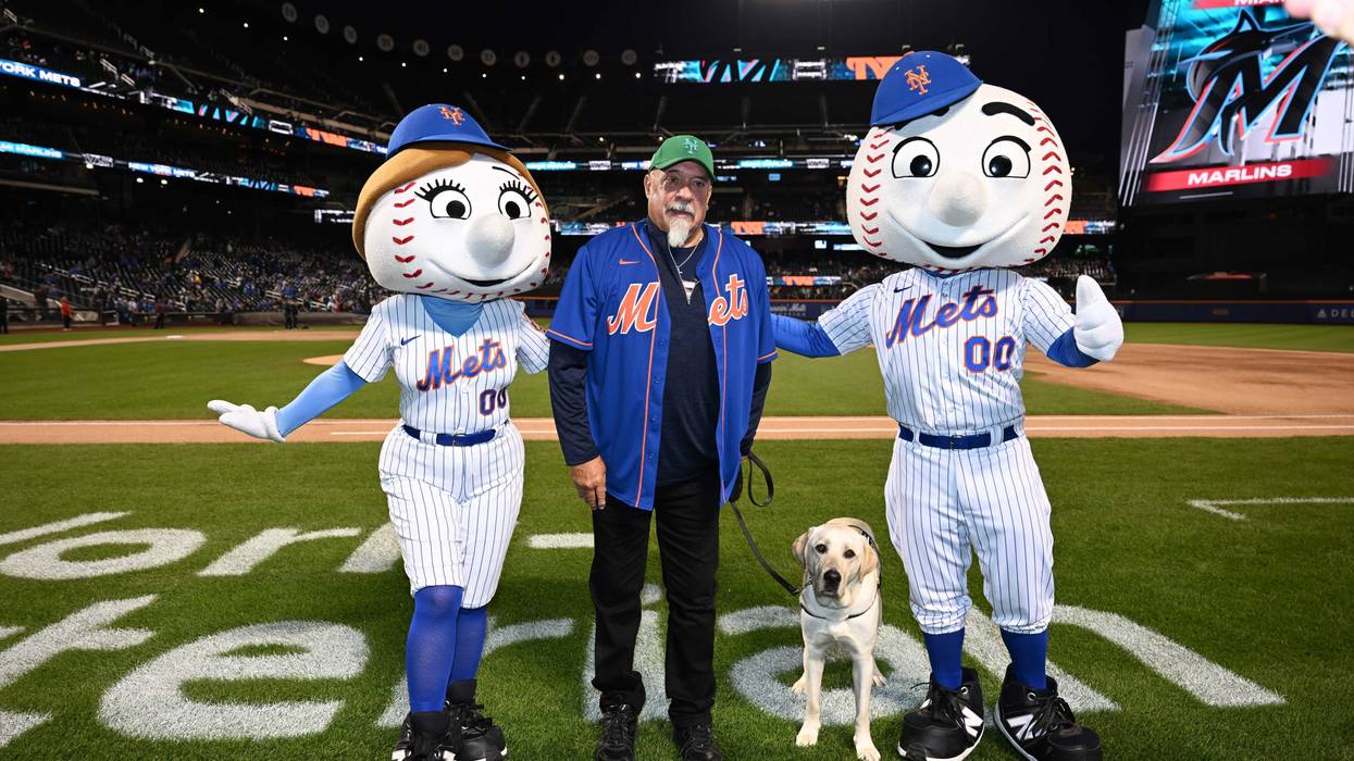 NYPD first responder, Richie Carter, and service dog, Shea at the pregame ceremony at Citi Field on Sept. 28, 2023.