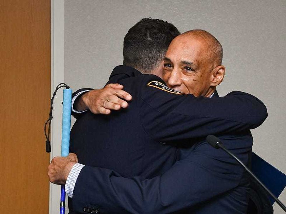 NYPD officer hugs rescued man