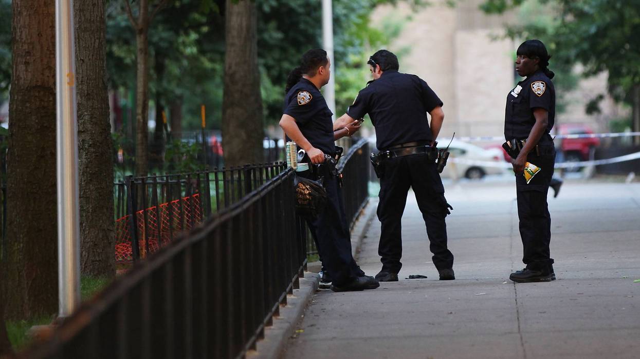 NYPD officers are seen by a crime scene.