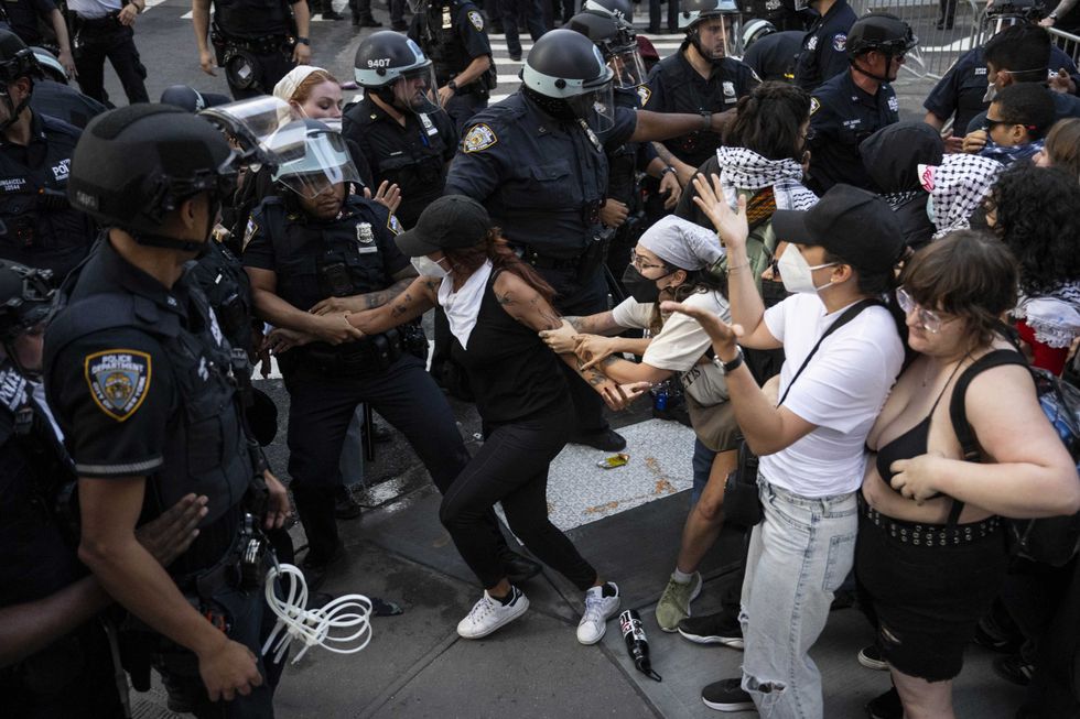 NYPD officers arrest a demonstrator during an anti-ICE protest outside 26 Federal Plaza Building on June 10, 2025