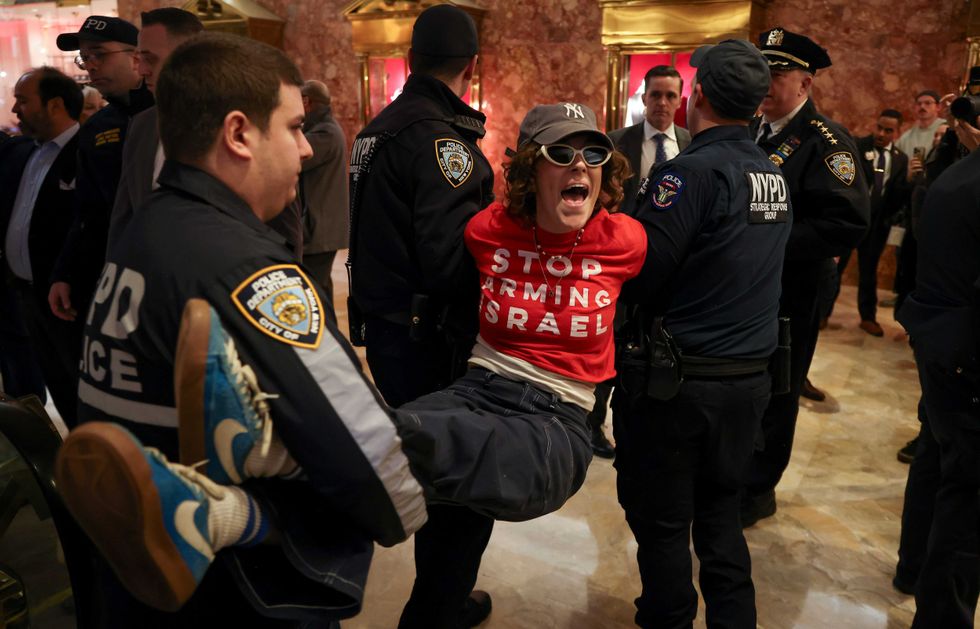 NYPD officers arrest a demonstrator from the group, Jewish Voice for Peace, who protested inside Trump Tower in support of Columbia graduate student Mahmoud Khalil, Thursday, March 13, 2025, in New York