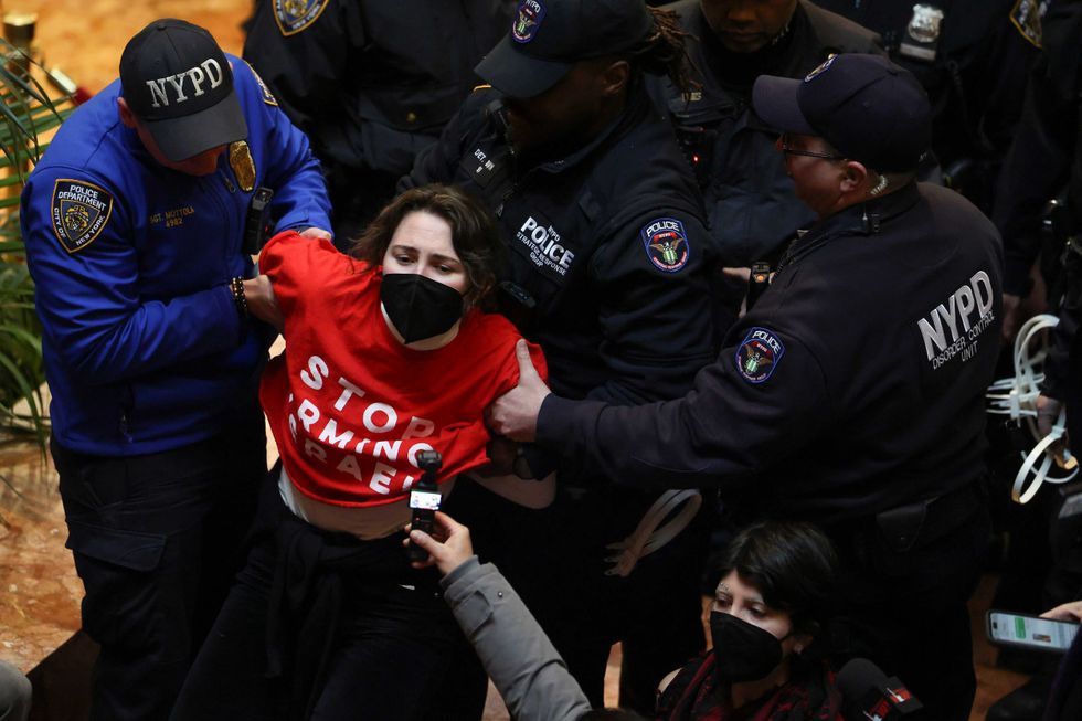 NYPD officers arrest a demonstrator from the group, Jewish Voice for Peace, who protested inside Trump Tower in support of Columbia graduate student Mahmoud Khalil, Thursday, March 13, 2025, in New York