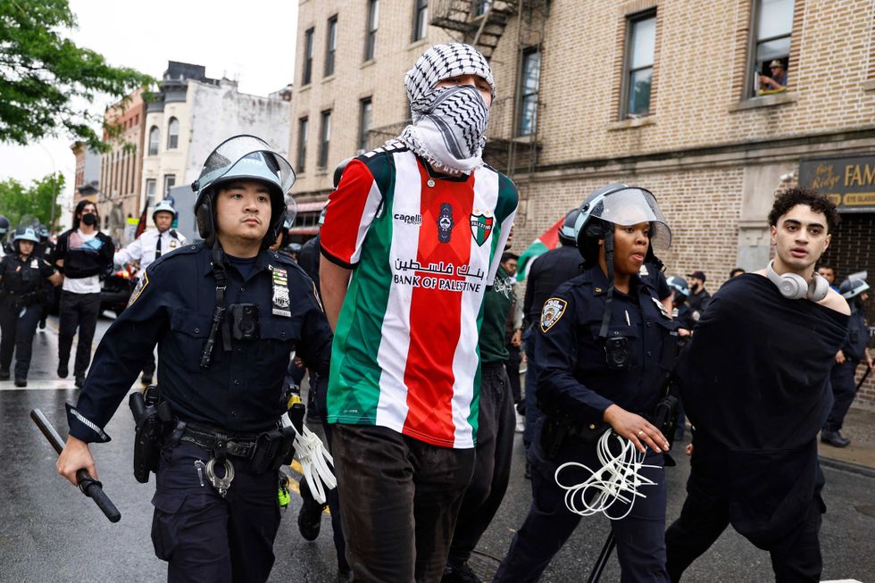 NYPD officers arrest pro-Palestinian demonstrators during a rally in Brooklyn on May 18, 2024