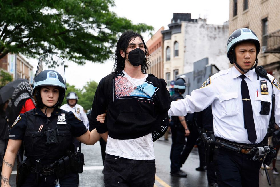 NYPD officers arrest pro-Palestinian demonstrators during a rally in Brooklyn on May 18, 2024.