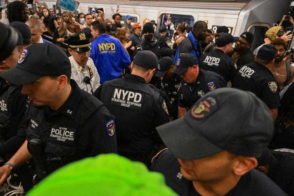 NYPD officers arrests protesters in the Lexington Ave/63rd Street subway Station during a "Justice for Jordan Neely" protest on May 6, 2023