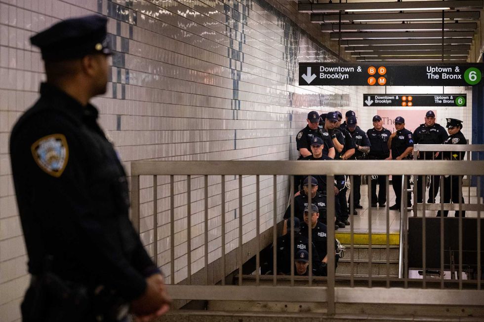 NYPD officers from the Special Response Group (SRG) unit wait inside the Broadway-Lafayette subway station ahead of a "Justice for Jordan Neely" vigil and protest on May 8, 2023