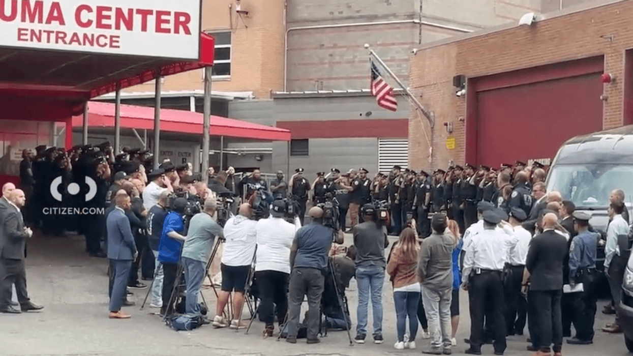 NYPD officers gather to support the two officers as they leave Elmhurst Hospital.