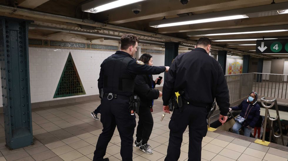 NYPD officers investigate an assault at the 125th Street station on the Lexington Avenue line