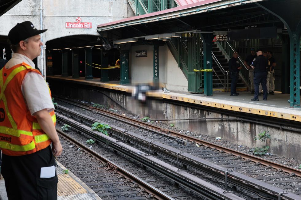 NYPD officers investigate the scene of a man hit by a train at the Prospect Park subway stop on July 30, 2025