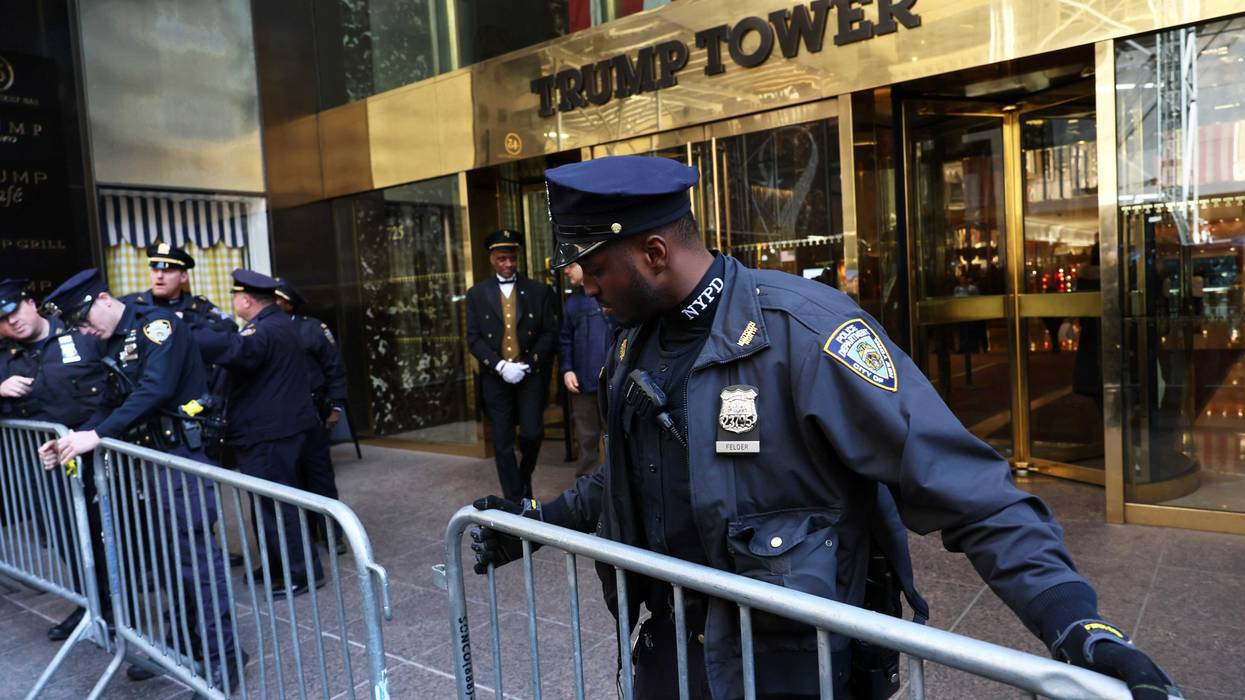 NYPD officers place metal barricades outside of Trump Tower on March 21, 2023