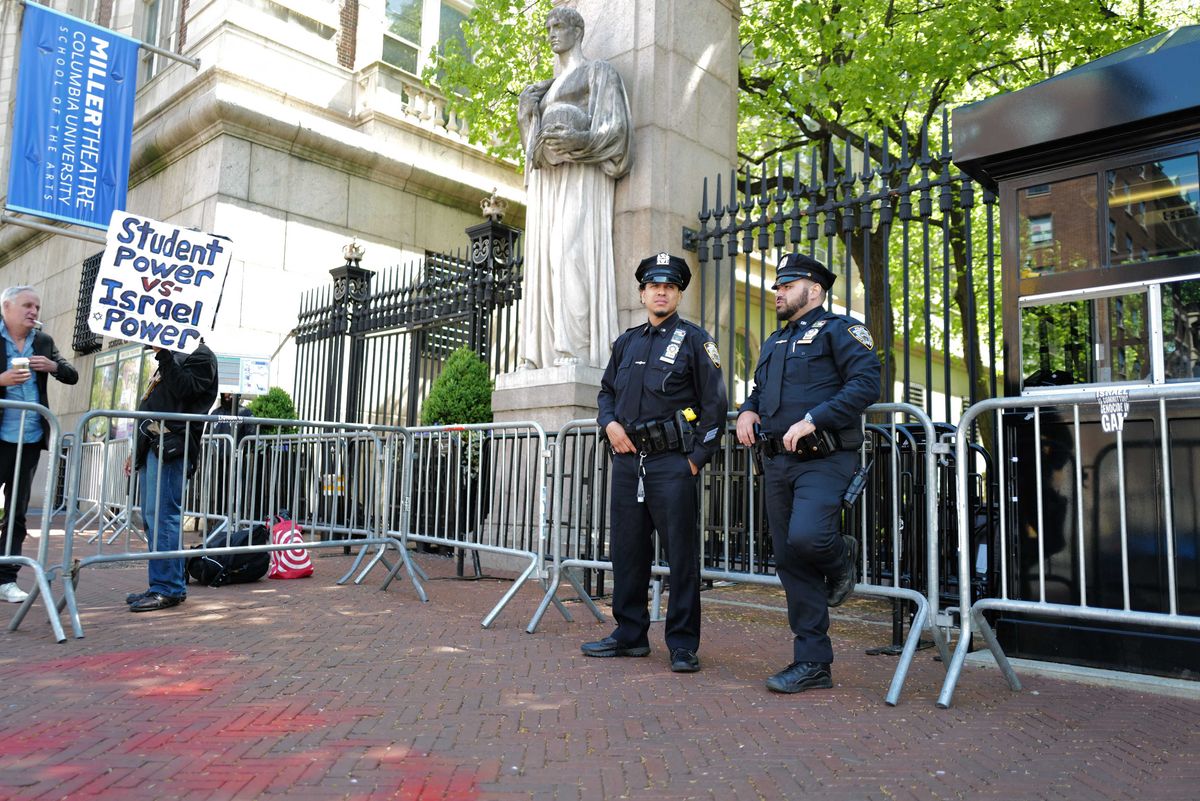 NYPD officers stand at the entrance of Columbia University on May 1, 2024