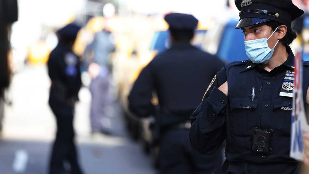 NYPD officers stand guard as people gather to protest vaccine mandates for city workers at City Hall Park on November 03, 2021 in New York City. Protestors gathered at City Hall Park to protest the mandatory unpaid leave for city workers for refusing Mayor Bill de Blasio's coronavirus (COVID-19) vaccine mandate. The group also protested New York City Mayor-elect Eric Adams "flip-flop" on vaccine mandates for workers and students.