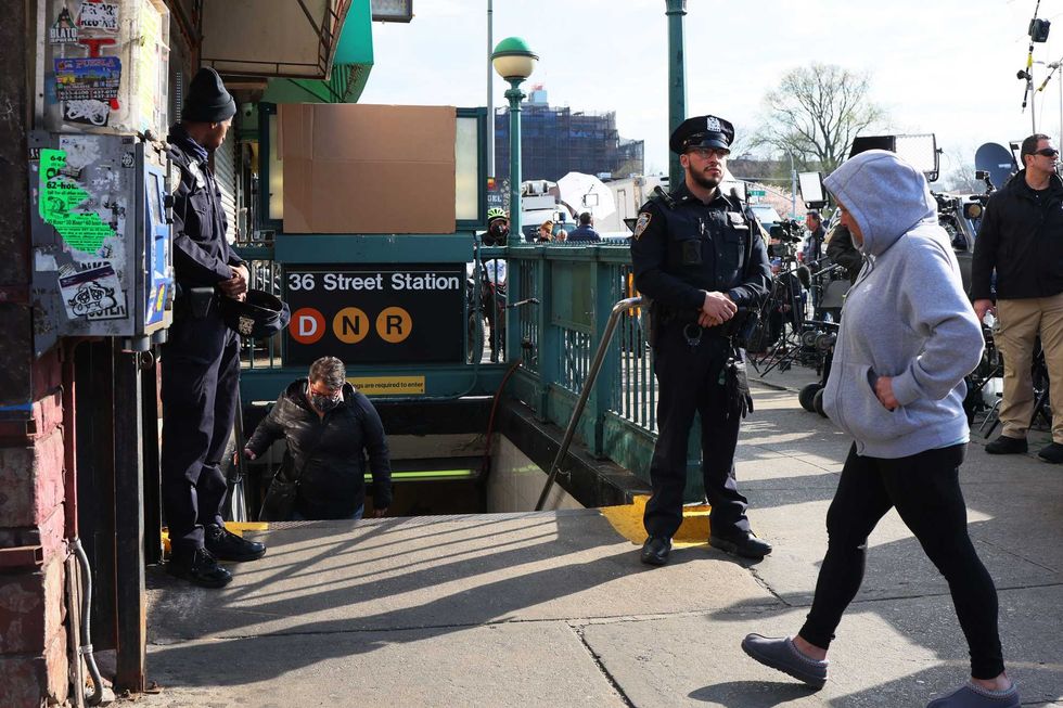 NYPD officers stand guard at the 36th Street subway station on April 13, 2022 in Sunset Park, Brooklyn