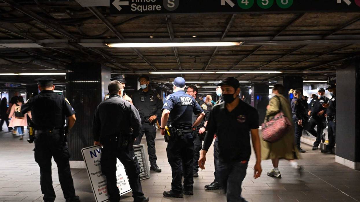 NYPD officers stand near the 4/5/6 lines at Grand Central Station