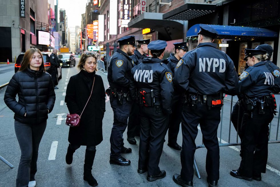 NYPD officers stand watch in Times Square in New York City ahead of the New Year