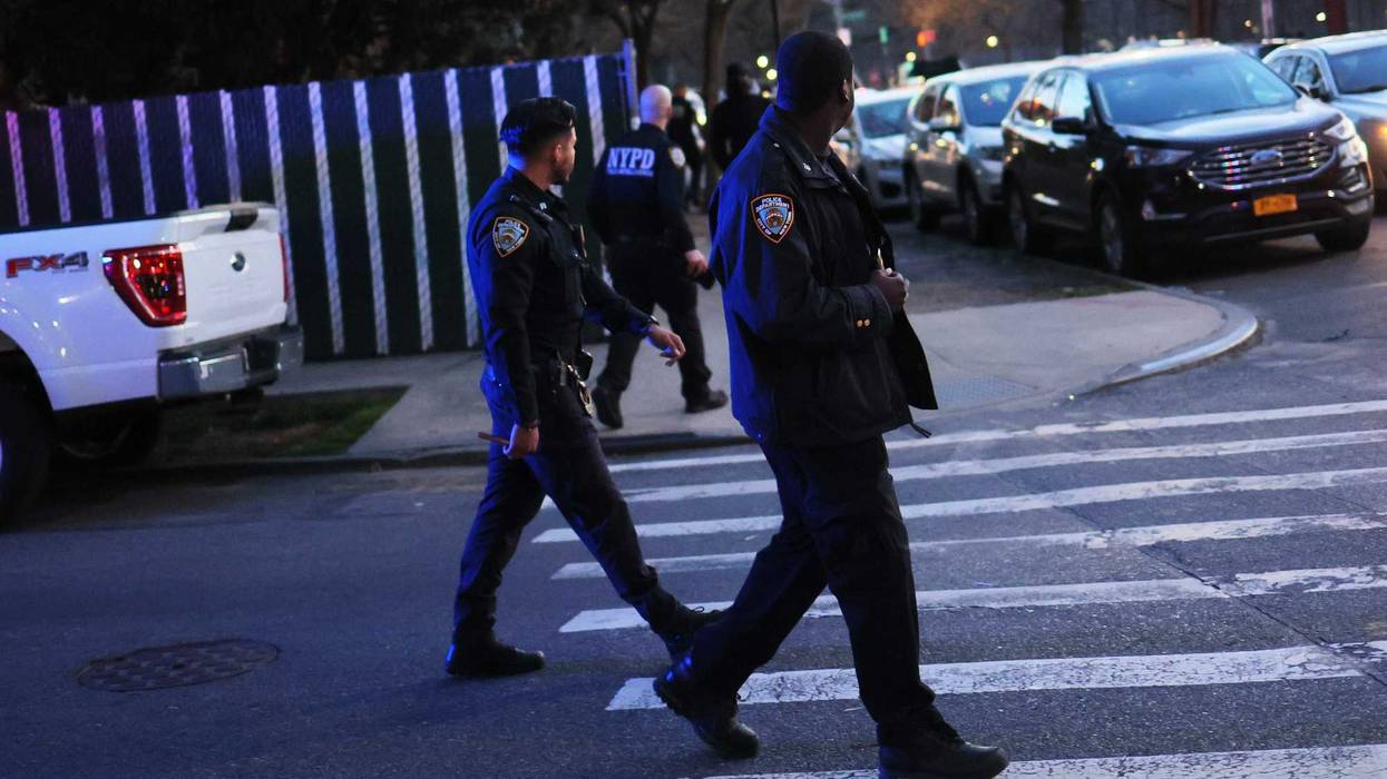 NYPD officers walk back to their patrol cars after an arrest on April 20, 2022 in the Flatbush neighborhood of Brooklyn