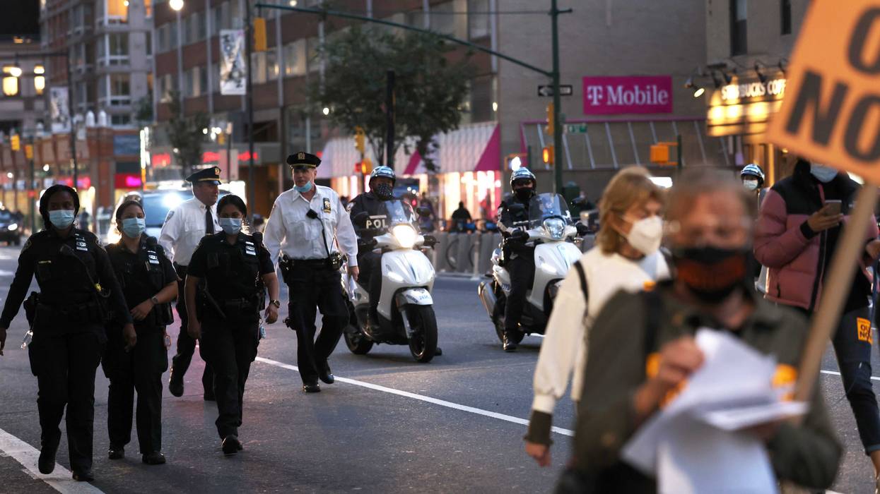 NYPD officers walk behind demonstrators as they march against "Death, Lies, and Fascism, and for Humanity!" on September 21, 2020 in New York City.