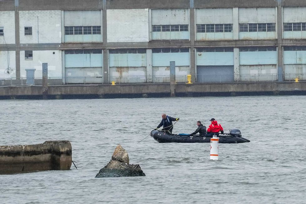 NYPD scuba divers team search next to the site of a crashed helicopter on the Hudson River on April 11, 2025 in Jersey City