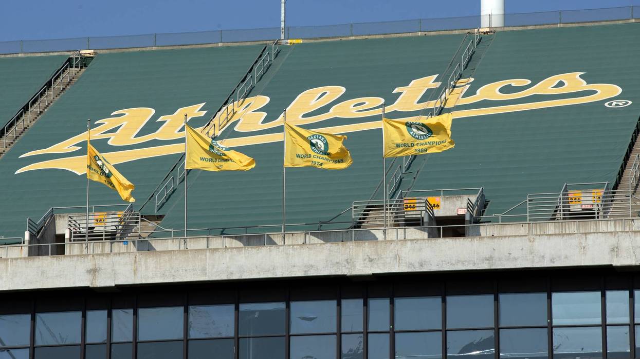Oakland Athletics championship flags fly over the grandstand at RingCentral Coliseum.
