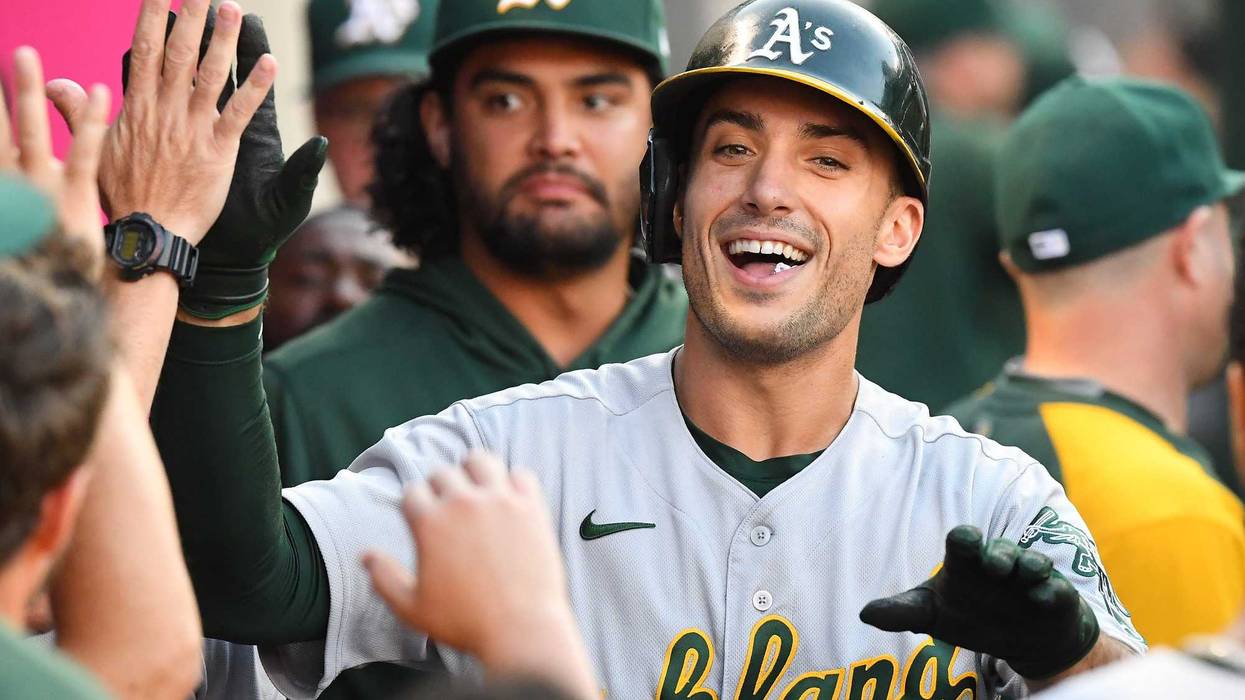 Oakland Athletics first baseman Matt Olson (28) is congratulated in the dugout after hitting a solo home run against the Los Angeles Angels in the first inning at Angel Stadium.