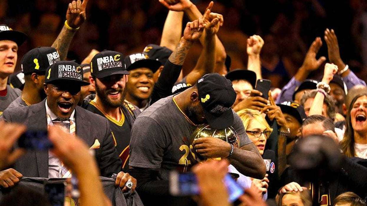 OAKLAND, CA - JUNE 19: LeBron James #23 of the Cleveland Cavaliers holds the Larry O'Brien Championship Trophy after defeating the Golden State Warriors 93-89 in Game 7 of the 2016 NBA Finals at ORACLE Arena on June 19, 2016 in Oakland, California. NOTE T