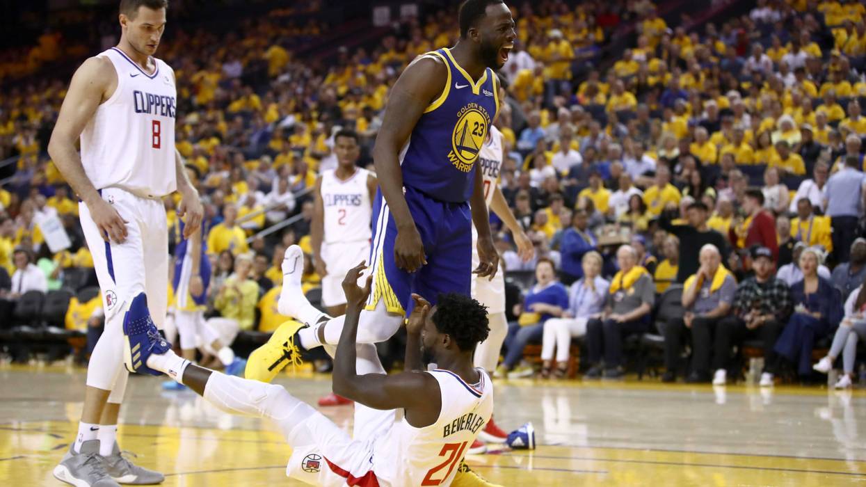 OAKLAND, CALIFORNIA - APRIL 24: Draymond Green #23 of the Golden State Warriors gets tangled wth Patrick Beverley #21 of the LA Clippers after Green was called for an offensive foul during Game Five of the first round of the 2019 NBA Western Conference Playoffs at ORACLE Arena on April 24, 2019 in Oakland, California