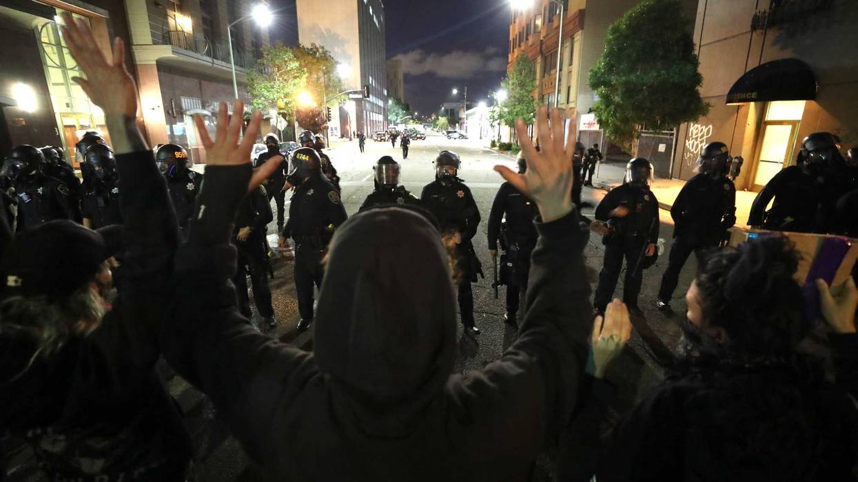 OAKLAND, CALIFORNIA - MAY 29: Demonstrators hold up their arms during a protest sparked by the death of George Floyd while in police custody on May 29, 2020 in Oakland, California.
