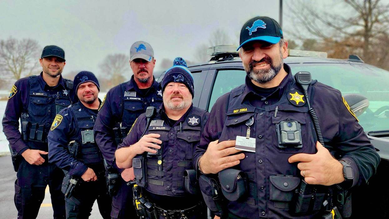 Oakland County Sheriff's Department personnel wearing Detroit Lions hats