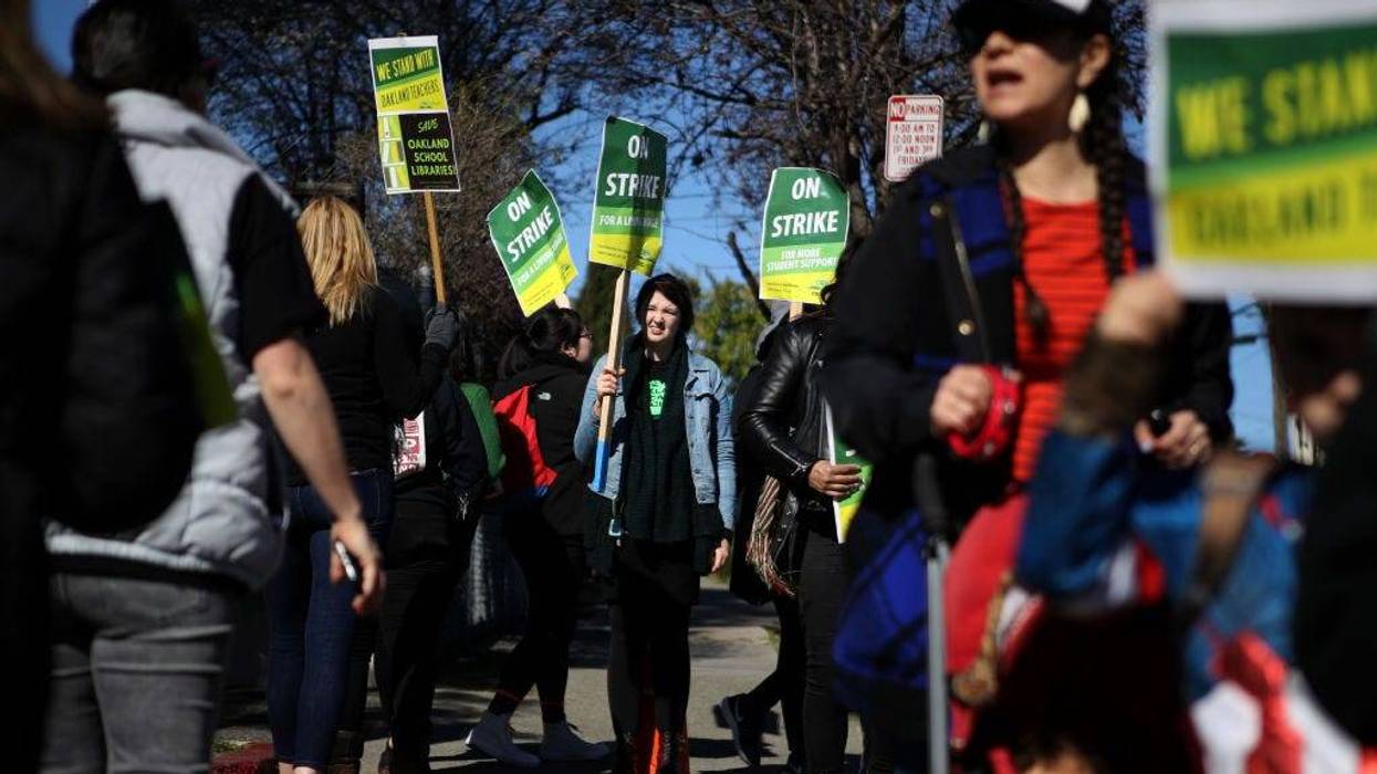Oakland Unified School District students, teachers and parents carry signs as they picket outside of Manzanita Community School on February 21, 2019 in Oakland, California.