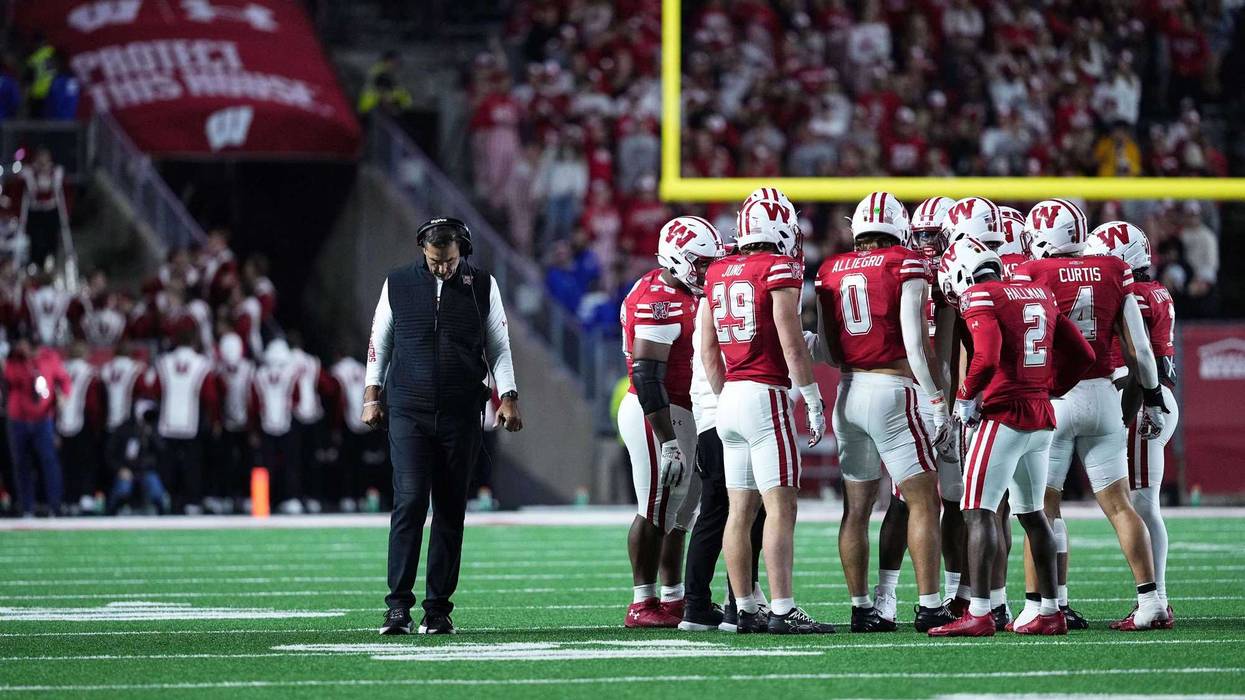 Oct 11, 2025; Madison, Wisconsin, USA; Wisconsin Badgers head coach Luke Fickell and his team take a timeout in the second half against the Iowa Hawkeyes at Camp Randall Stadium. Mandatory Credit: Ross Harried-Imagn Images
