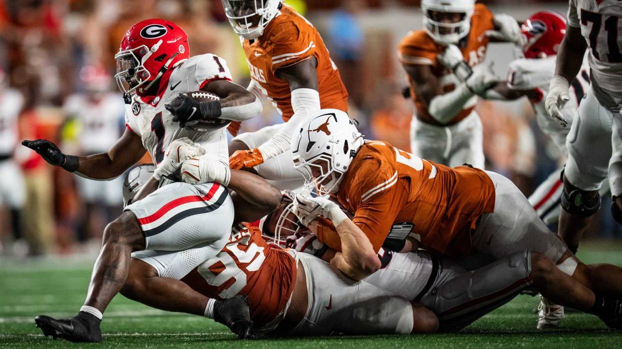 Oct 19, 2024; Austin, Texas, USA; Texa defense works to bring down Georgia Bulldogs wide receiver Arian Smith (11) in the fourth quarter of the game against the Georgia Bulldogs at Darrell K Royal-Texas Memorial Stadium. Sara Diggins/USA TODAY Network via Imagn Images