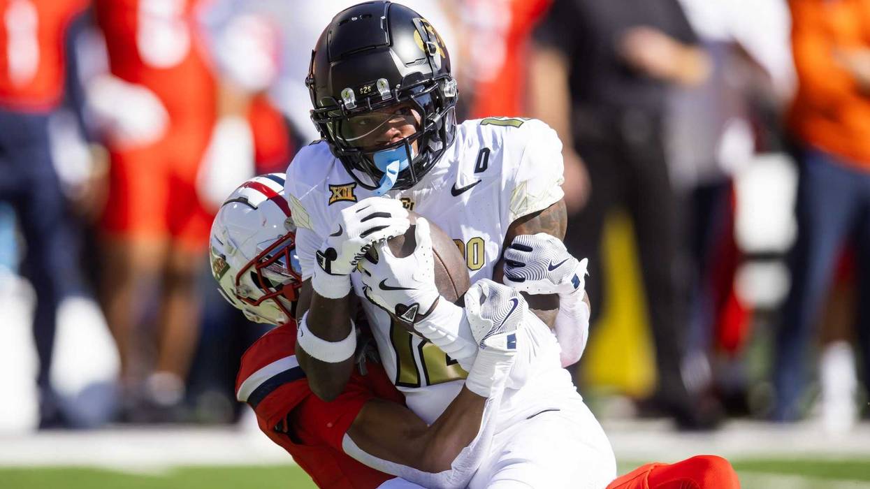 Oct 19, 2024; Tucson, Arizona, USA; Colorado Buffalos wide receiver Travis Hunter (12) is tackled by Arizona Wildcats cornerback Tacario Davis (1) at Arizona Stadium.