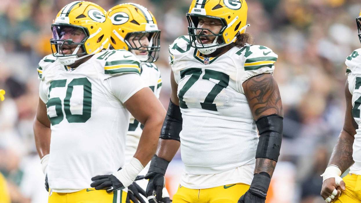 Oct 19, 2025; Glendale, Arizona, USA; Green Bay Packers offensive lineman Zach Tom (50) and guard Jordan Morgan (77) against the Arizona Cardinals at State Farm Stadium. Mandatory Credit: Mark J. Rebilas-Imagn Images