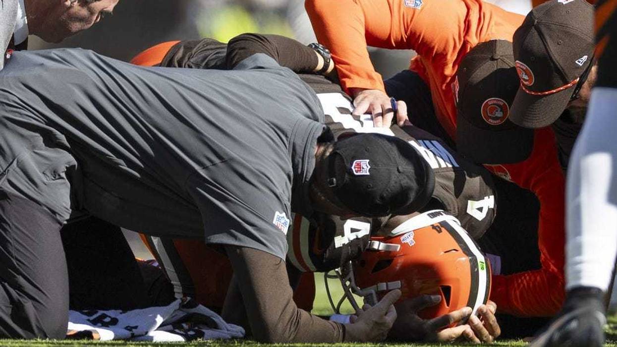 Oct 20, 2024; Cleveland, Ohio, USA; Cleveland Browns quarterback Deshaun Watson (4) is attended to by head coach Kevin Stefanski and team medical personnel for his torn Achilles during the second quarter against the Cincinnati Bengals at Huntington Bank Field.