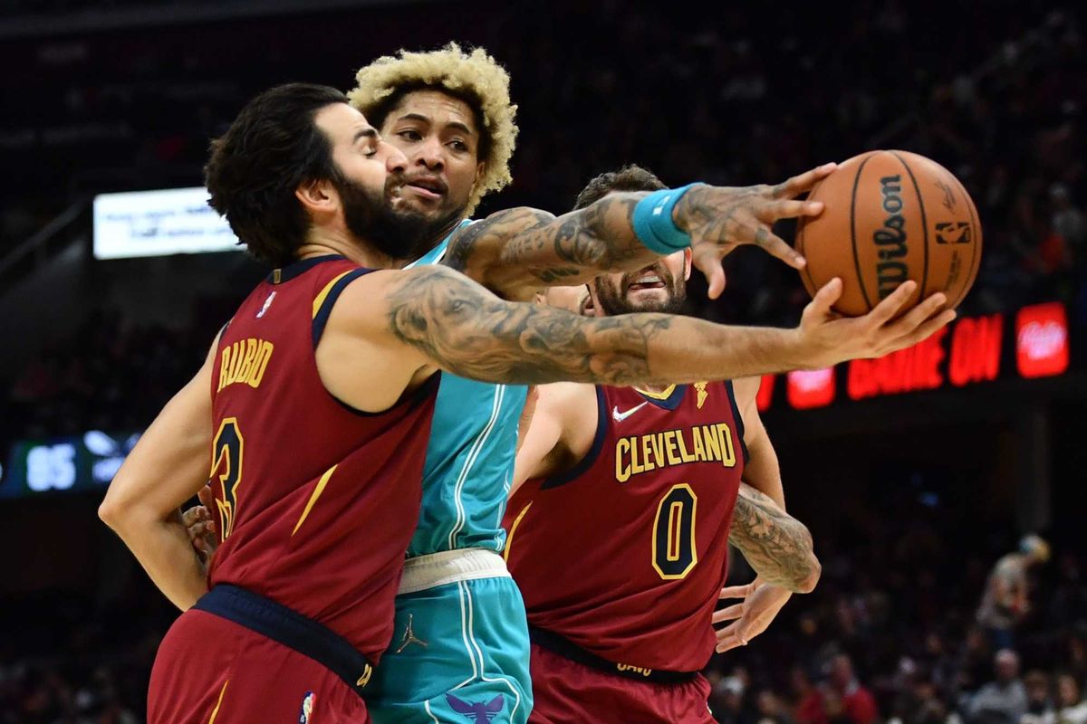 Oct 22, 2021; Cleveland, Ohio, USA; Charlotte Hornets guard Kelly Oubre Jr. (12) fouls Cleveland Cavaliers guard Ricky Rubio (3) during the second half at Rocket Mortgage FieldHouse.