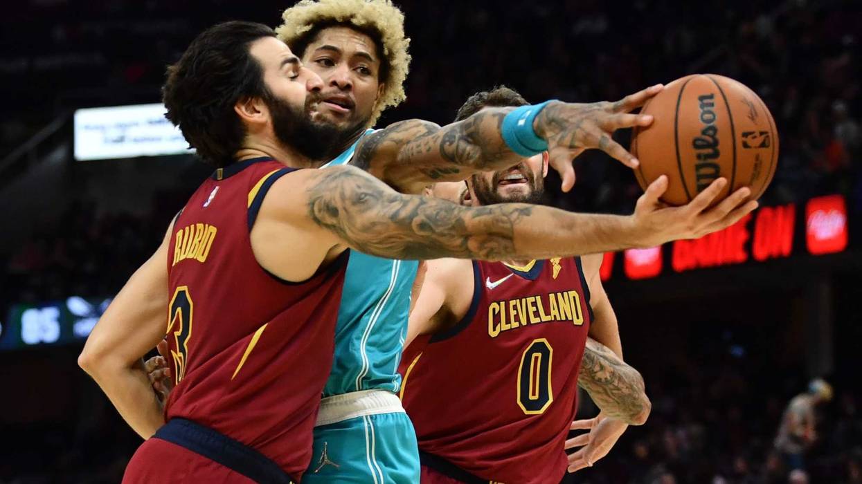 Oct 22, 2021; Cleveland, Ohio, USA; Charlotte Hornets guard Kelly Oubre Jr. (12) fouls Cleveland Cavaliers guard Ricky Rubio (3) during the second half at Rocket Mortgage FieldHouse.