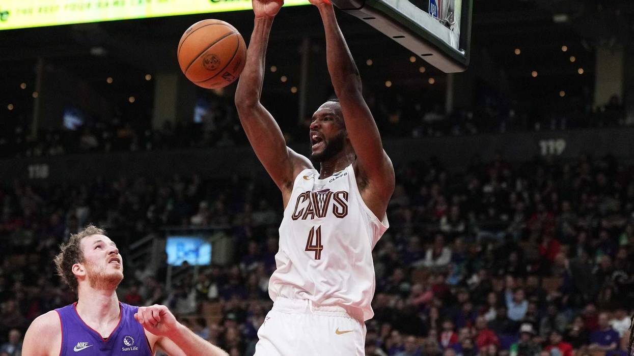 Oct 23, 2024; Toronto, Ontario, CAN; Cleveland Cavaliers forward Evan Mobley (4) scores a basket over Toronto Raptors center Jakob Poeltl (19) during the third quarter at Scotiabank Arena.