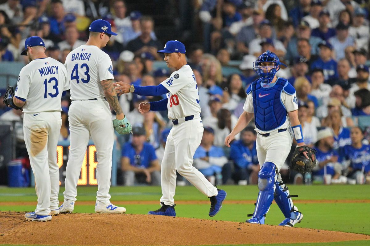 Oct 28, 2025; Los Angeles, California, USA; Los Angeles Dodgers manager Dave Roberts (30) pulls Los Angeles Dodgers pitcher Anthony Banda (43) from the game during the seventh inning against the Toronto Blue Jays during game four of the 2025 MLB World Series at Dodger Stadium. Mandatory Credit: Jayne Kamin-Oncea-Imagn Images