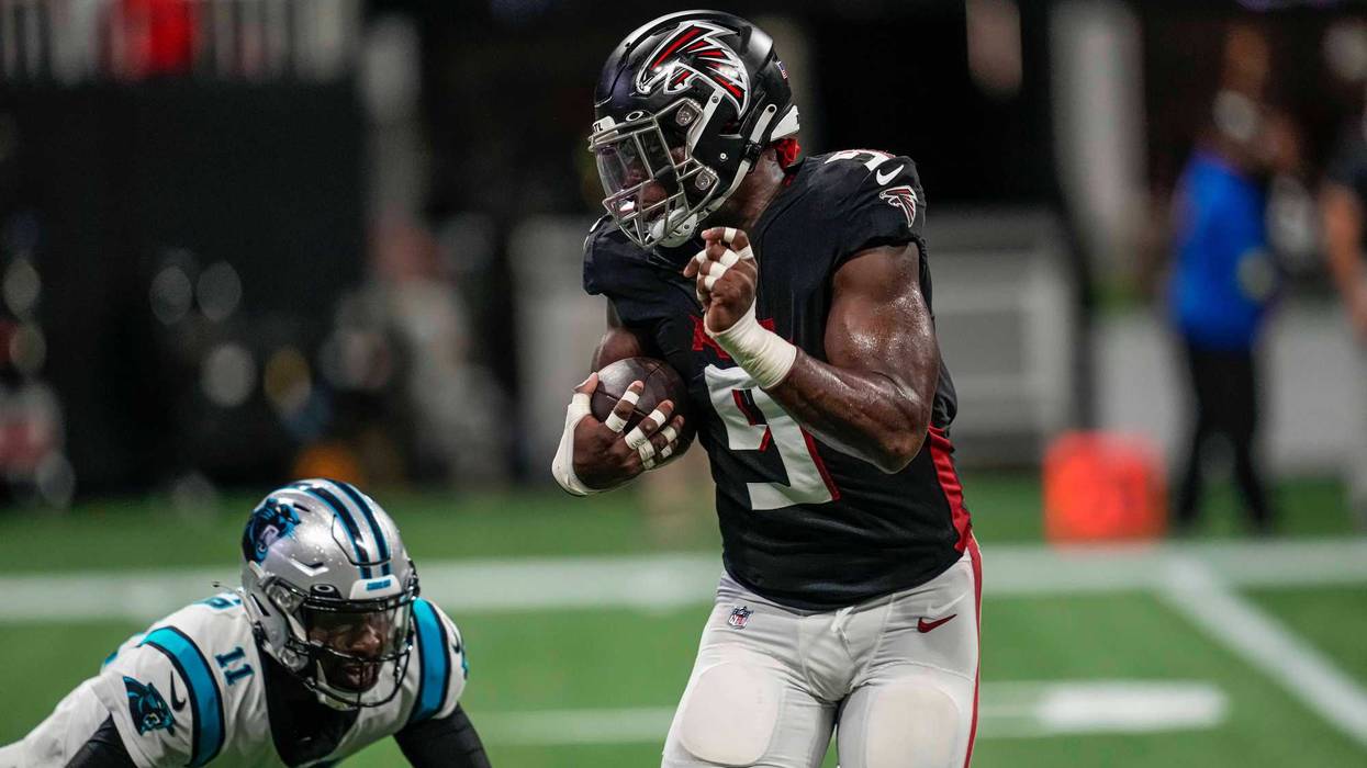 Oct 30, 2022; Atlanta, Georgia, USA; Atlanta Falcons linebacker Lorenzo Carter (9) returns a pass interception for a touchdown past Carolina Panthers quarterback PJ Walker (11) during the first half at Mercedes-Benz Stadium.