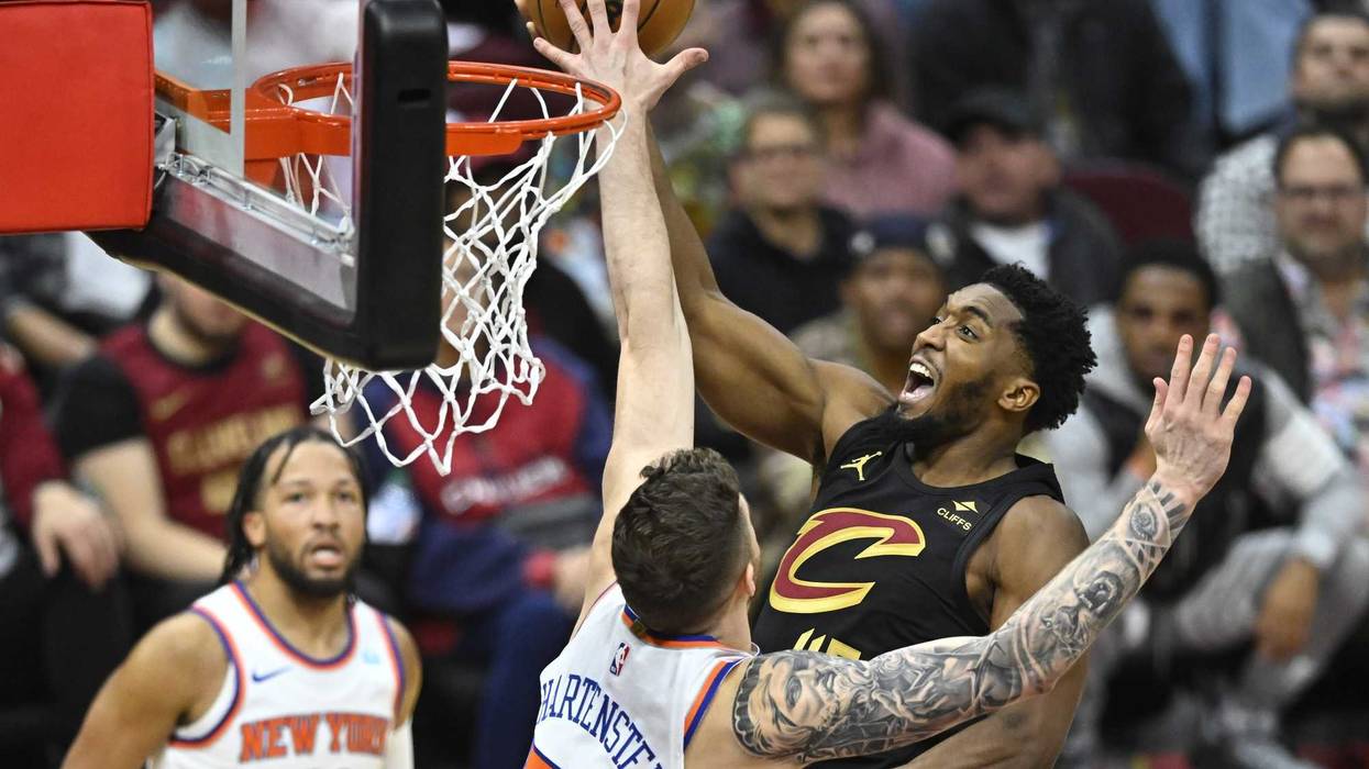 Oct 31, 2023; Cleveland, Ohio, USA; Cleveland Cavaliers guard Donovan Mitchell (45) shoots beside New York Knicks center Isaiah Hartenstein (55) in the third quarter at Rocket Mortgage FieldHouse.